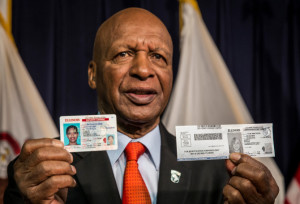 Illinois Secretary of State Jesse White shows the new driver's license that will feature upgraded security, left. He also held the temporary paper license that will be issued at license facilities. | Rich Hein/Sun-Times