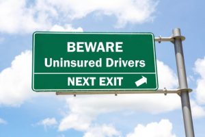 Street Sign Reads Uninsured Drivers