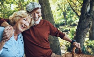 An elderly couple enjoying a picnic